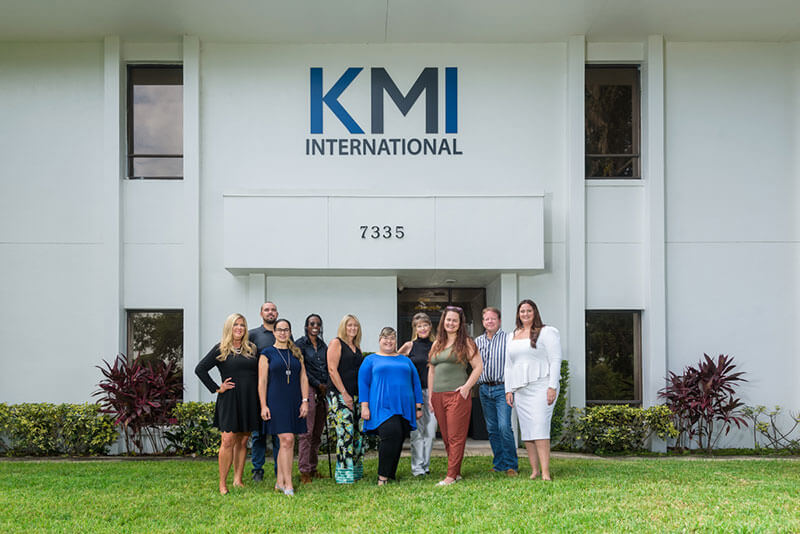 KMI Team in front of office building