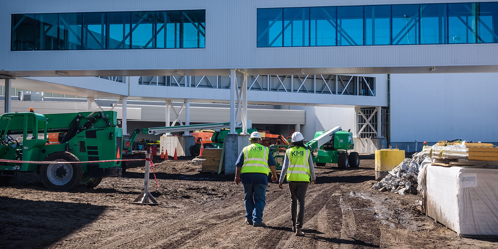 two employees walking a construction site